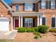 Inviting front porch with red door, white columns, and manicured landscaping at 320 Falesco Ln, Matthews, NC 28105
