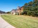 Beautiful brick homes with manicured lawns, large trees, and well-maintained landscaping at 320 Falesco Ln, Matthews, NC 28105