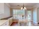 Eat-in kitchen featuring a breakfast table, tile floor, and white cabinets and stainless steel appliances at 320 Falesco Ln, Matthews, NC 28105