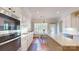 Modern kitchen featuring white cabinets, stainless steel appliances, and a central island with tile flooring at 320 Falesco Ln, Matthews, NC 28105