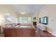 Bright living room featuring a fireplace, hardwood floors, and a comfortable leather sectional sofa at 320 Falesco Ln, Matthews, NC 28105