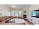 Inviting living room showcasing a fireplace, hardwood floors, and a comfortable leather sectional sofa at 320 Falesco Ln, Matthews, NC 28105