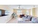 Cozy living room boasts a large window, ceiling fan, work space, and comfortable gray couch at 320 Falesco Ln, Matthews, NC 28105