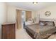 Comfortable bedroom with a patterned bedspread, a dark wood dresser, and natural light from a window at 3254 Pikes Peak Dr, Gastonia, NC 28052