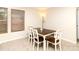 Cozy dining area with a dark wood table, white chairs, and natural light from a window at 3254 Pikes Peak Dr, Gastonia, NC 28052