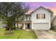 Charming two-story home with a manicured lawn, mature trees, and attached garage at 3254 Pikes Peak Dr, Gastonia, NC 28052