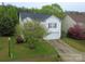 Lovely exterior of this home, featuring a well-kept lawn, attached garage, and mature landscaping at 3254 Pikes Peak Dr, Gastonia, NC 28052