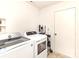 Bright laundry room with modern washer and dryer units and white door at 3254 Pikes Peak Dr, Gastonia, NC 28052