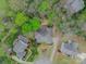 Bird's-eye view of the house surrounded by mature trees, other homes and its manicured lawn at 3866 Bethany Nw Ct, Concord, NC 28027