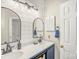 Bathroom featuring a double sink vanity with shiplap wall accents at 3866 Bethany Nw Ct, Concord, NC 28027