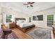 Spacious bedroom with tray ceiling, natural light, and wood floors at 3866 Bethany Nw Ct, Concord, NC 28027