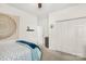 A bright bedroom showcases a bed with floral patterns and a cozy blue throw blanket at 3866 Bethany Nw Ct, Concord, NC 28027