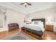Comfortable bedroom with tray ceiling, neutral walls, ceiling fan, and wood floors at 3866 Bethany Nw Ct, Concord, NC 28027