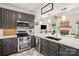 Open kitchen with stainless steel appliances and a view into the living area at 3866 Bethany Nw Ct, Concord, NC 28027