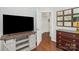 Stylish living room with hardwood floors, tv, and hallway entrance at 3866 Bethany Nw Ct, Concord, NC 28027