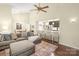 Open-concept living room with bar seating, fireplace, spacious sectional, and hardwood floors at 3866 Bethany Nw Ct, Concord, NC 28027