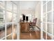 Cozy office space with hardwood floors, French doors, and a work space at 3866 Bethany Nw Ct, Concord, NC 28027