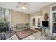 Relaxing screened patio with ceiling fan, tile flooring, and outdoor seating at 3866 Bethany Nw Ct, Concord, NC 28027