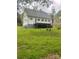 This is an exterior view of the backyard, including a wooden deck and green grass at 3921 Bon Rea Dr, Charlotte, NC 28226