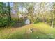 This lush backyard includes a shed for storage, trees, and green grass at 3921 Bon Rea Dr, Charlotte, NC 28226