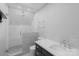 This modern bathroom features a glass shower with rainfall shower head and a white countertop vanity at 3921 Bon Rea Dr, Charlotte, NC 28226