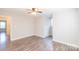 This spacious bedroom features sleek, modern, laminate flooring and a ceiling fan at 3921 Bon Rea Dr, Charlotte, NC 28226
