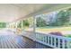 Spacious covered front porch with white railings and views of the surrounding landscape at 3921 Bon Rea Dr, Charlotte, NC 28226