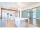 Expansive kitchen featuring dual islands, wood beam accents, and an open layout to the adjacent living space at 3921 Bon Rea Dr, Charlotte, NC 28226