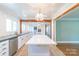 Bright, white kitchen with island, wood beams, and open floor plan to living area, great for entertaining at 3921 Bon Rea Dr, Charlotte, NC 28226