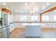 Spacious kitchen features a large island, stainless steel refrigerator and fixtures, and exposed wood beam at 3921 Bon Rea Dr, Charlotte, NC 28226
