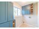 Laundry room with built-in blue cabinets and convenient storage solutions at 3921 Bon Rea Dr, Charlotte, NC 28226