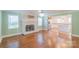 Bright living room with a brick fireplace, hardwood floors, and open layout to kitchen at 3921 Bon Rea Dr, Charlotte, NC 28226
