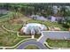 An aerial view of the community pool, lake, playground, and surrounding homes at 400 Eden Hollow Ln, Weddington, NC 28104