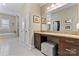 Bathroom vanity with granite counters and a makeup station in a brightly lit neutral colored space at 400 Eden Hollow Ln, Weddington, NC 28104