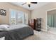 Bedroom with natural light from window, dresser, neutral colored walls and carpet with a bathroom in the hall at 400 Eden Hollow Ln, Weddington, NC 28104
