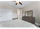 Bedroom with natural light from window, ceiling fan, dresser, and neutral colored walls and carpet at 400 Eden Hollow Ln, Weddington, NC 28104
