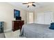 Well-lit bedroom with ceiling fan, TV and dresser with neutral colored walls and carpet at 400 Eden Hollow Ln, Weddington, NC 28104
