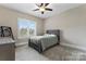 Bedroom with natural light from window, neutral walls, gray carpet and unique bed frame at 400 Eden Hollow Ln, Weddington, NC 28104