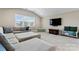 Comfortable bonus room featuring a sectional sofa, large windows, and a mounted television at 400 Eden Hollow Ln, Weddington, NC 28104