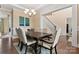 Beautiful dining room with elegant chairs, wood table, and a view of the foyer staircase at 400 Eden Hollow Ln, Weddington, NC 28104