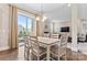 Light-filled dining area with patio access, leading to living room with fireplace and mounted TV at 400 Eden Hollow Ln, Weddington, NC 28104