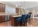 Bright kitchen with island seating, stainless appliances, tile backsplash, and lots of natural light at 400 Eden Hollow Ln, Weddington, NC 28104
