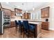 Modern kitchen with stainless steel appliances, granite countertops, and a breakfast bar with seating at 400 Eden Hollow Ln, Weddington, NC 28104