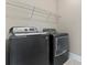 Modern laundry room with gray front-load washer and dryer, offering convenience and functionality at 400 Eden Hollow Ln, Weddington, NC 28104