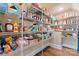 Walk-in pantry with ample shelving provides plenty of storage for food items and household supplies at 400 Eden Hollow Ln, Weddington, NC 28104