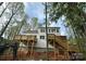 Multi-level deck with stairs provides outdoor living space and access to backyard, surrounded by trees at 4125 Hemingway Dr, Hickory, NC 28601