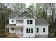 New two-story home featuring white board and batten siding, a gray roof, and a welcoming front porch at 4125 Hemingway Dr, Hickory, NC 28601