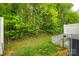 Backyard with a fenced-in patio area, leading to a grassy area surrounded by lush trees at 413 Lexie Ln # 92, Rock Hill, SC 29732