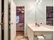A bathroom featuring a white vanity sink, leading to a bedroom with a bed and ceiling fan at 413 Lexie Ln # 92, Rock Hill, SC 29732