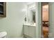 Bright bathroom with vanity, well-lit mirror, and a clean, inviting design, next to an open doorway at 413 Lexie Ln # 92, Rock Hill, SC 29732